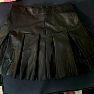 Black size medium pleated faux leather skirt never worn.